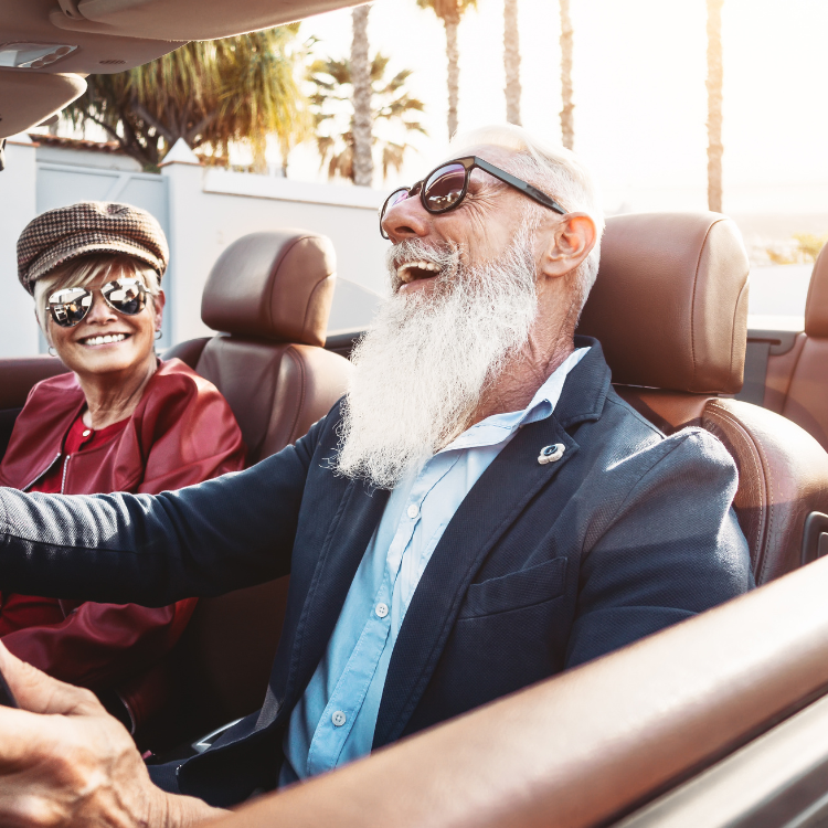 Couple driving in convertible