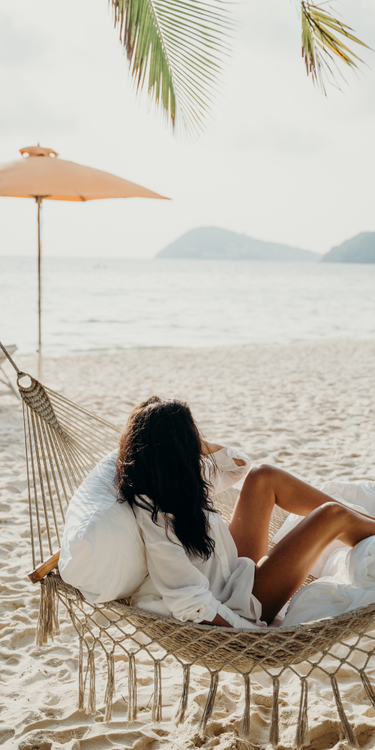 Brunette woman in Hammock on the beach