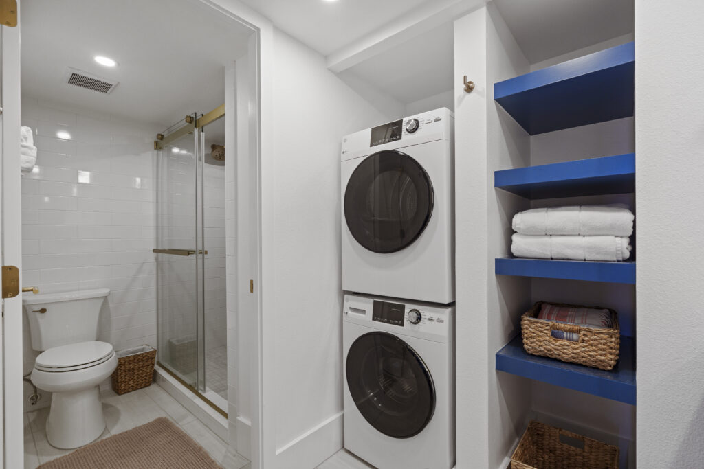 White washer and dryer frontloading stack in bathroom