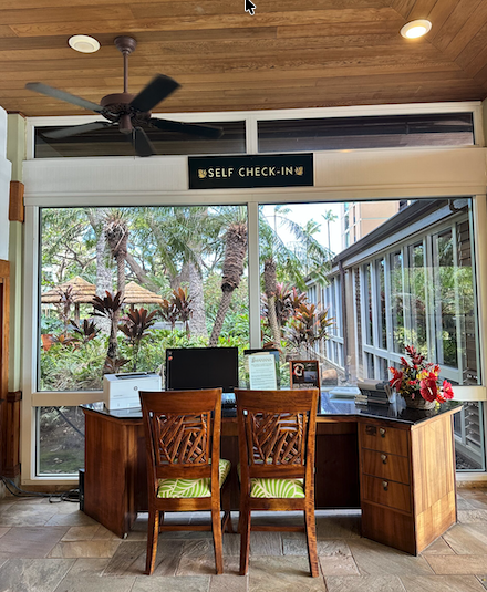 Self check-in station on property: 2 chairs and desk with computer