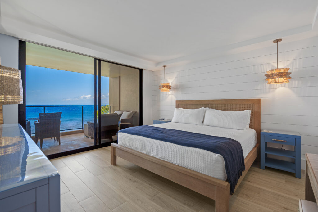 After remodel image of bedroom: kingsized bed with ocean view siding door to patio