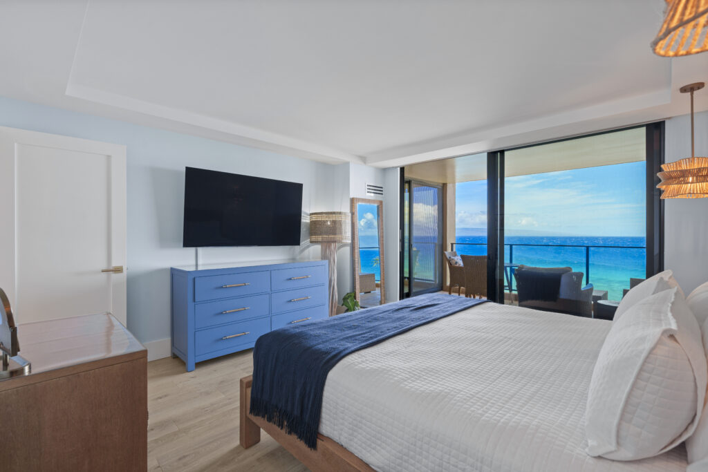 After remodel image of bedroom: kingsized bed with ocean view siding door to patio