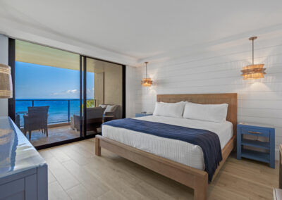 After remodel image of bedroom: kingsized bed with ocean view siding door to patio