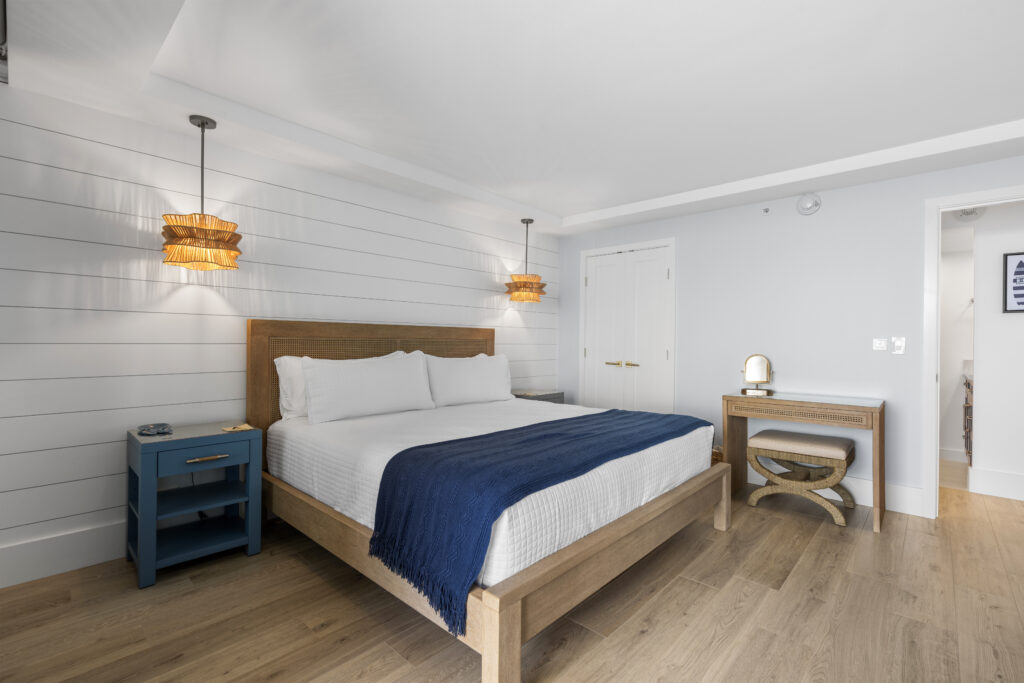 Modern and bright bedrrom with queen sized bed and writing desk