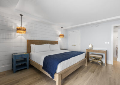 Post-remodel: Modern and bright bedrrom with queen sized bed and writing desk