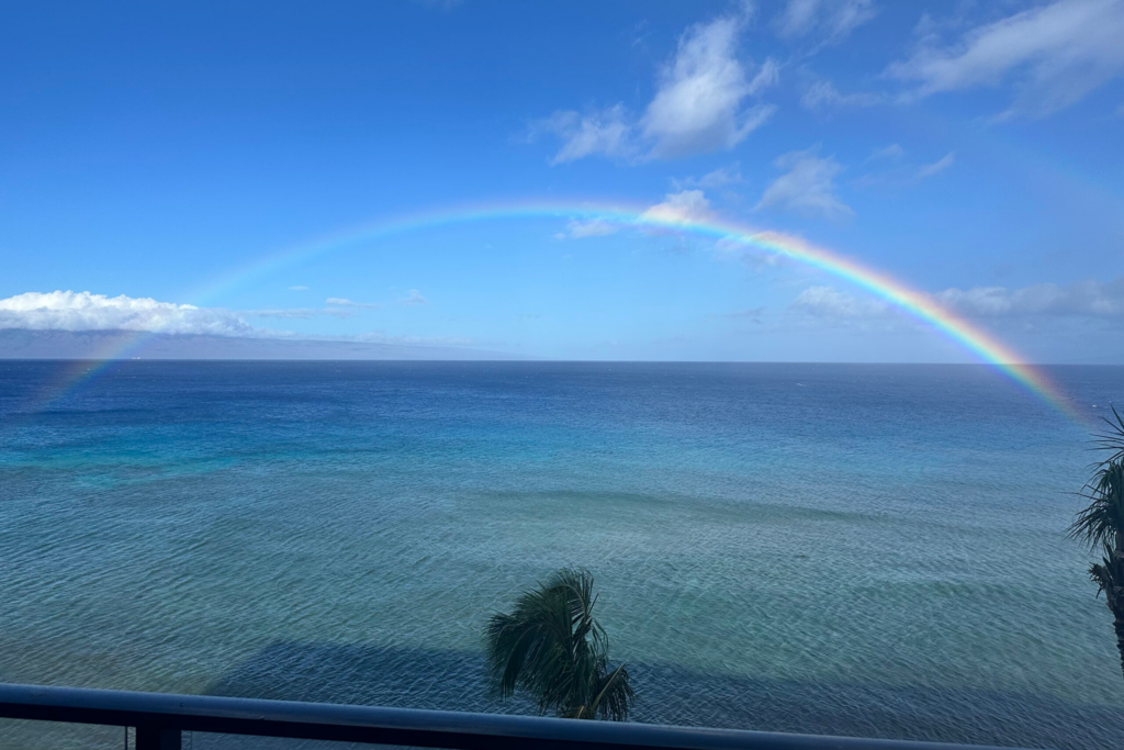 Bright blue sweeping ocean view with outer island of Lanai in distance.